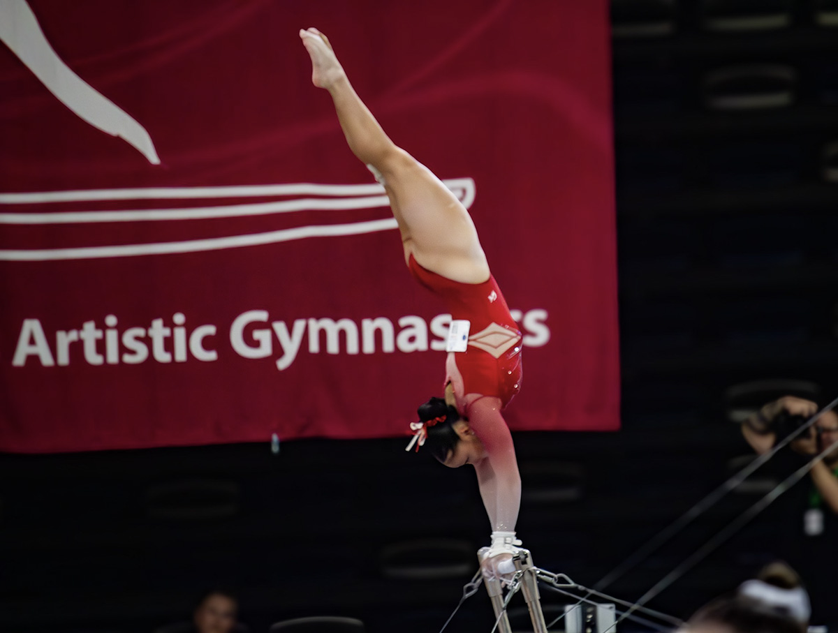 A gymnast on uneven bars