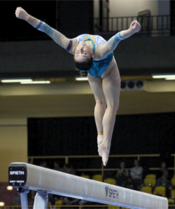 Kate McDonald competing on beam